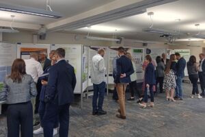 Sala posterowa. Ludzie oglądają postery.